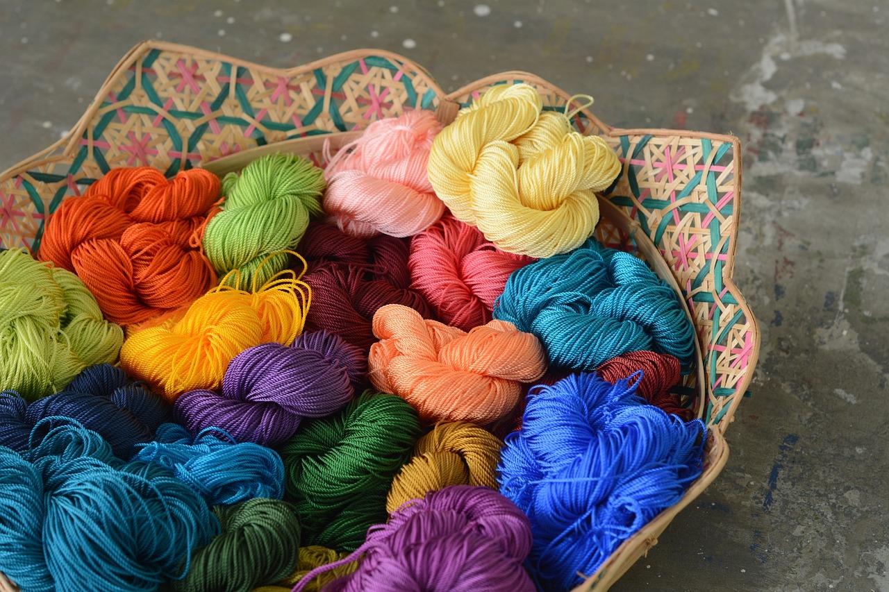 A basket of colorful yarn  Description automatically generated with medium confidence